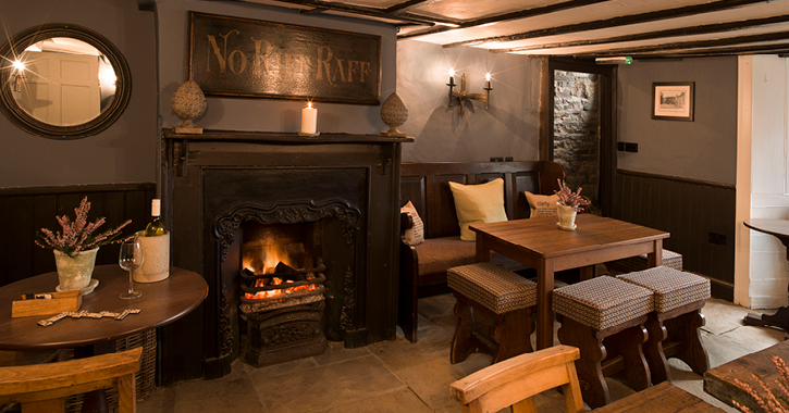 cosy seating area by open fire inside The Lord Crew Arms Hotel